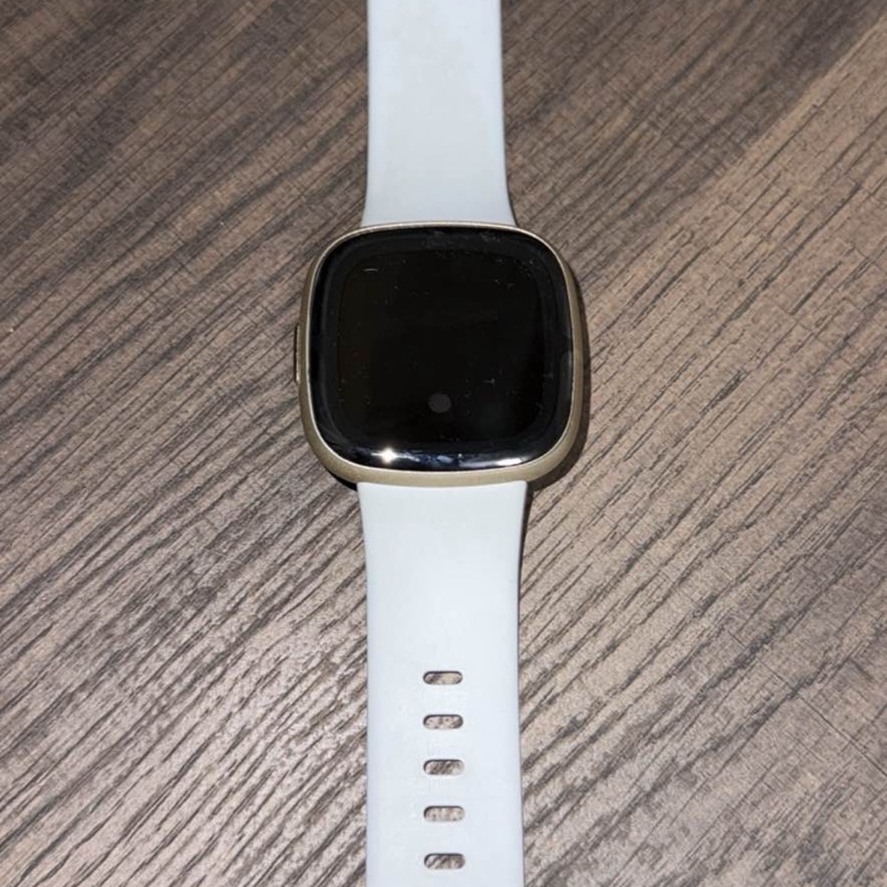 Fitbit Smartwatch with White Band and Black Display